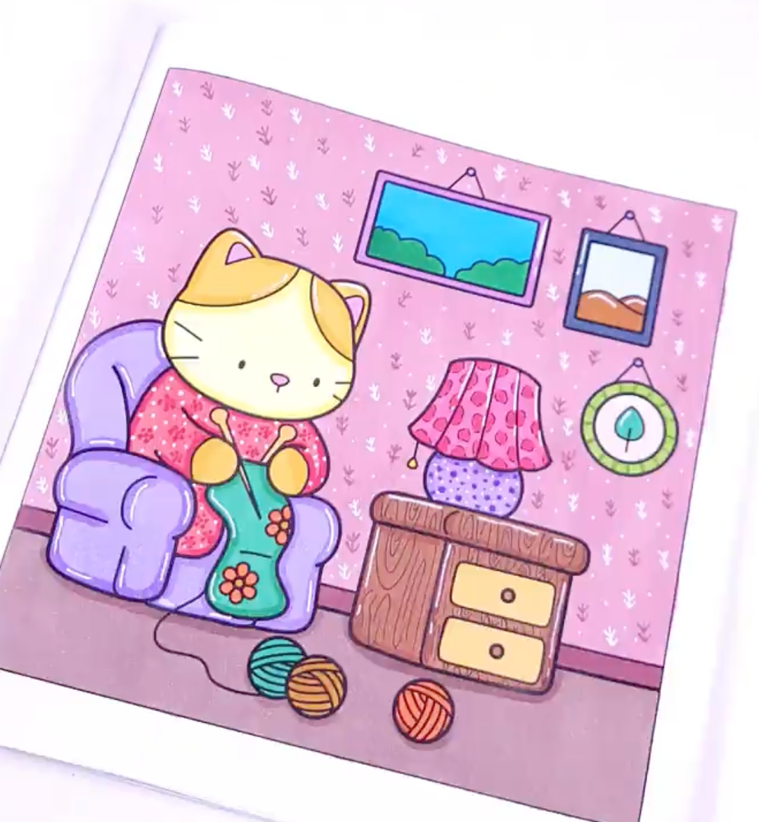 Colored example of a cat knitting in a cozy armchair, from Cozy Vibes coloring pages